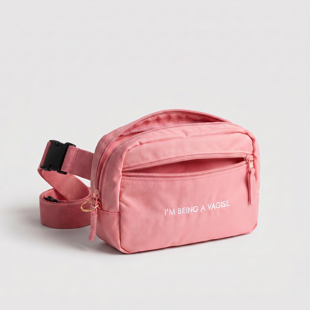 Pink waist bag with 'I'M BEING A VAGISL" text on a light gray background