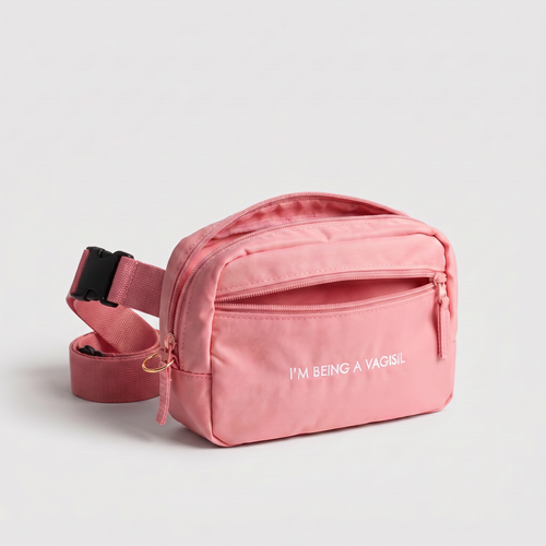 Pink waist bag with 'I'M BEING A VAGISL" text on a light gray background